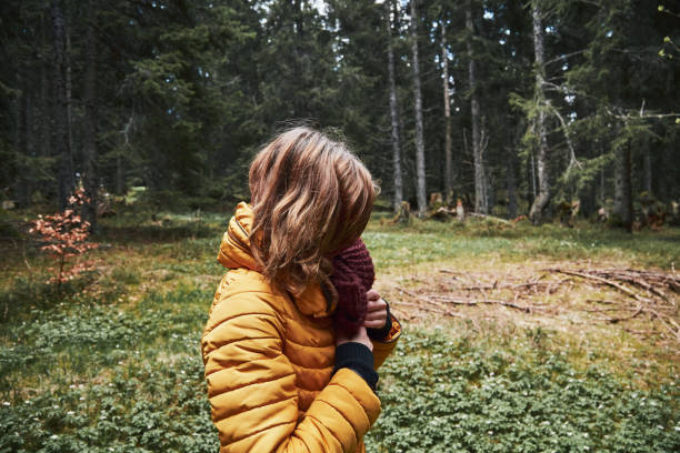 Abandoned desperate woman walking in a dark forest alone.