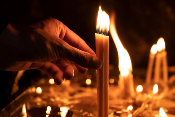 istock man hand candle in church 1248949656