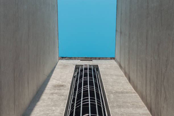 istock Emergency fire escape staircases on a building exterior with blue sky above 1248950306