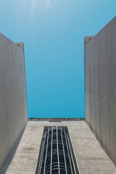 istock Emergency fire escape staircases on a building exterior with blue sky above 1248950310