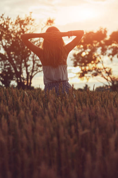 istock Young woman enjoying in a wheat field. 1248950507