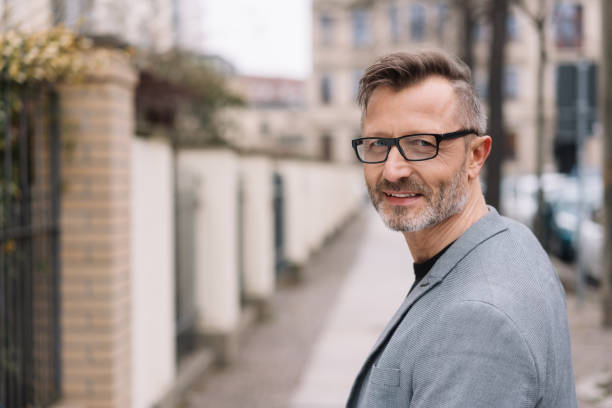 istock Mature, metro man smiling at camera in urban scene 1248950582