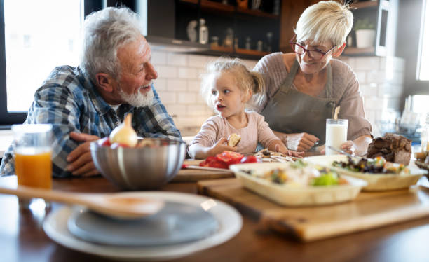 istock Happy grandparents with grandchildren making breakfast in kitchen 1248951661