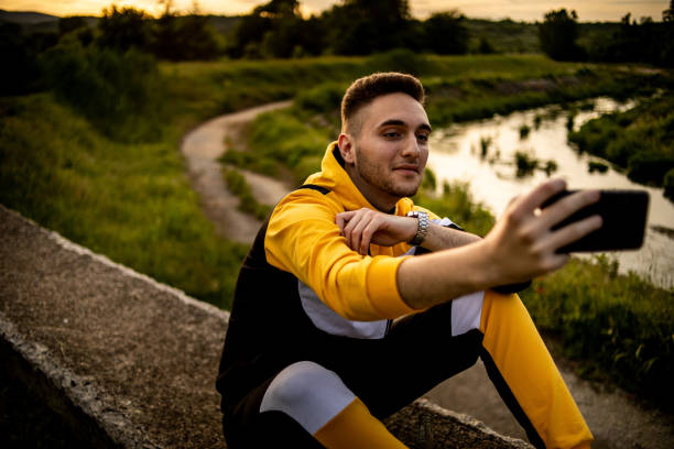 istock The young man sits in nature and enjoys the sunset 1248951914
