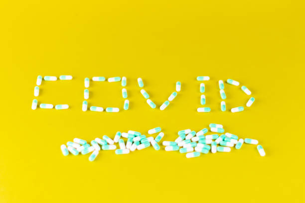 istock word covid written with blue pills on a blue background 1248953724