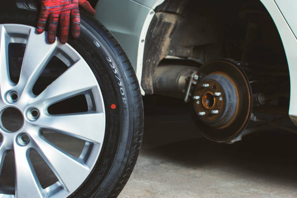 istock Car mechanic pushes the alloy wheels 1248953764
