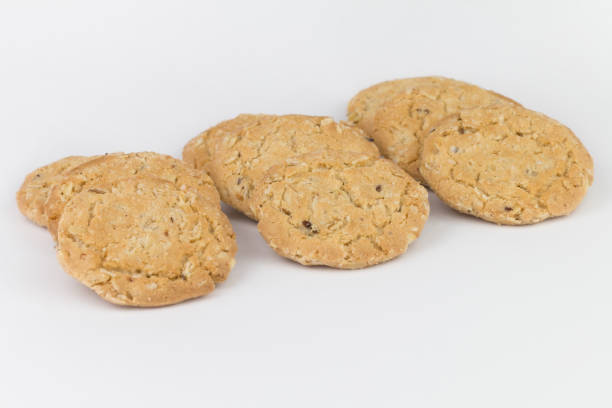 istock Closeup cereal cookies are arranged in multiple pieces and have three rows, and the cookies are brown and the image has a blank area next to the object and has a white background. 1248955187