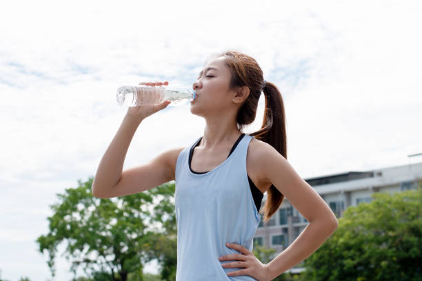 istock Asian runners are drinking water after training. 1248955939