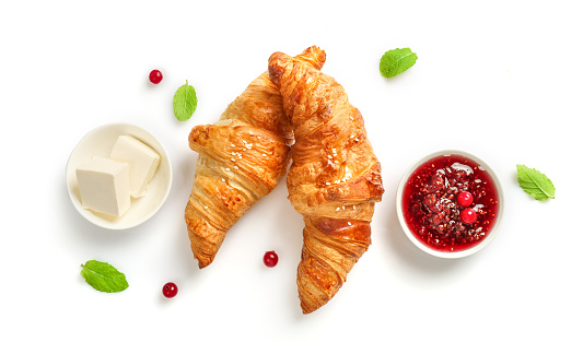 Fresh croissants and jam on white background. Top view.