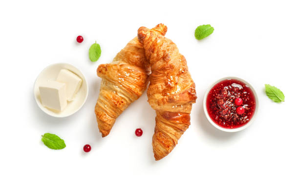 Delicious breakfast with fresh croissants Fresh croissants and jam on white background. Top view. crescent photos stock pictures, royalty-free photos & images
