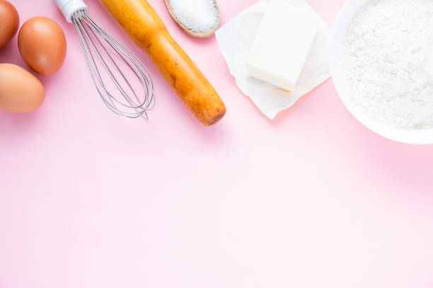 istock Baking background on a pastel pink background. Ingredients and tools for cooking food. 1248956458
