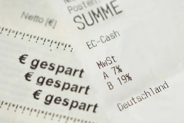 Photo of german cash sales receipt. Invoice with vat tax value. VAT rate from 19 percent to 16% and from 7 percent to 5%. financial / invoice - deutschland - germany. german word gespart - saved money