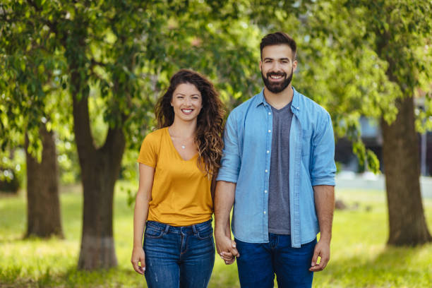 istock Young couple in love, taking a walk through the park holding hands 1248963358