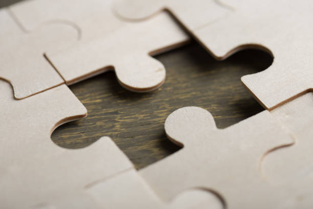 istock Creative solution for idea - business concept, jigsaw puzzle on the wooden desk 1248964923