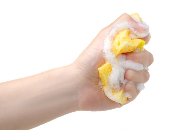 istock Yellow cleaning sponge with soap foam in hand 1248965070