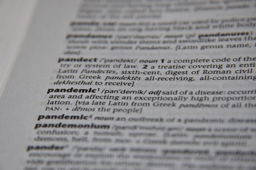 Dictionary definition of Pandemic. Close up view of horizontal text for editorial news article and reporting copy space.