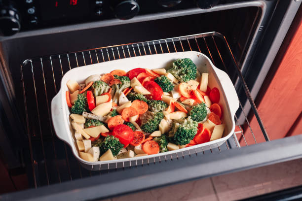 istock Sliced vegetables in a white ceramic bowl on the oven grate 1248965992