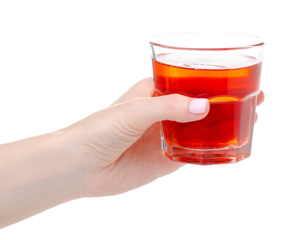istock Glass of red compote juice in hand 1248966152