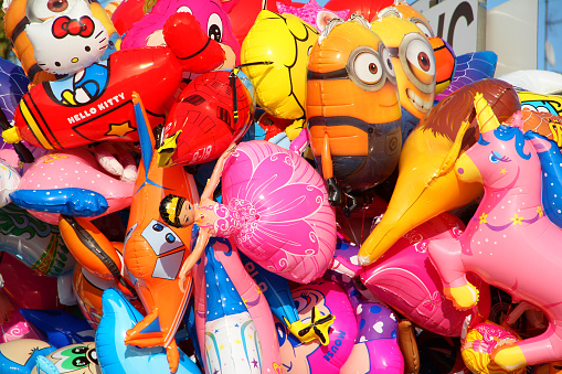 Stuttgart, Germany - October 01, 2014: Helium filled balloons with faces of many famous cartoon characters at the Stuttgart Beer Festival (Cannstatter Volksfest).