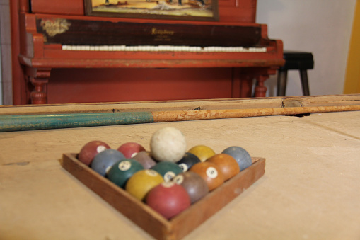 antique billiard table with balls