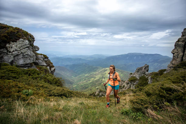 istock Young woman running on mountain 1248971616