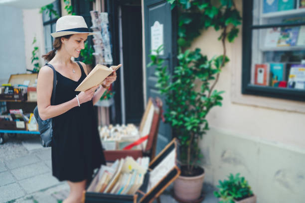 istock Woman choosing book from old bookstore 1248972870