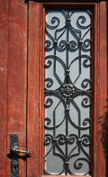 istock old  wooden door,wrought iron window 1248973770