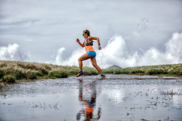 istock Young woman running on mountain 1248973987