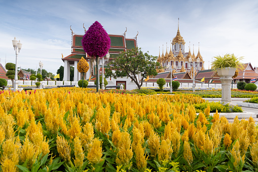 The ornate golden spires of Loha Prasat in the Wat Ratchanatdaram temple complex in the heart of Bangkok, Thailand's vibrant capital city.