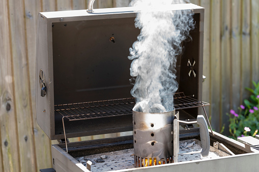 Barbecue charcoal starter chimney. This gadget creates an updraft to get charcoal lit and burning more quickly. It uses a firelighter at the base and the flames go up through the charcoal following the airflow.