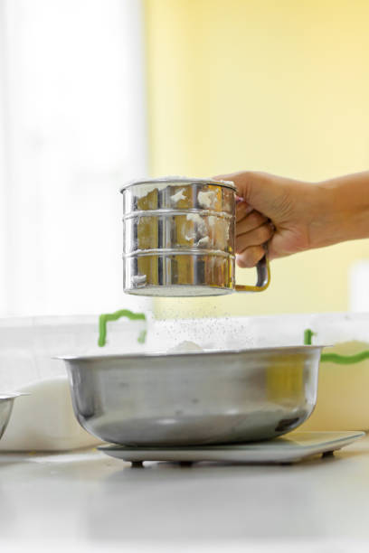 cooking baking. cook sifts the flour close up - cake making mixing eggs imagens e fotografias de stock