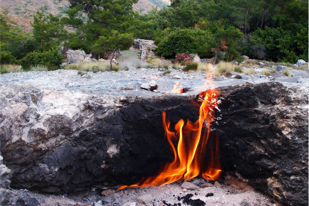 Flames of Chimera mount, burning natural gas underground, rocks in Cirali, Turkey Flames of Chimera mount, burning natural gas underground, rocks in Cirali, Turkey cirali stock pictures, royalty-free photos & images