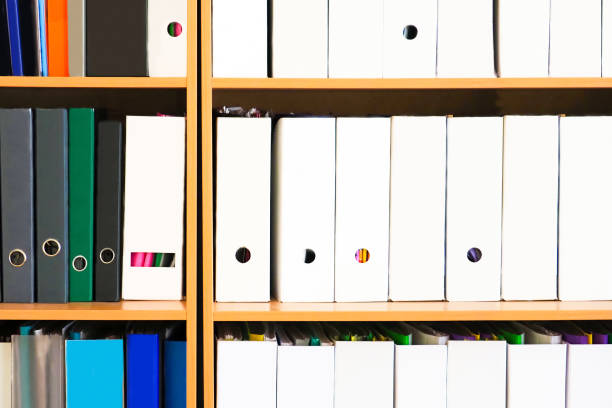 istock Shelving with folders. Stack of business papers on the wood shelfs 1248978989