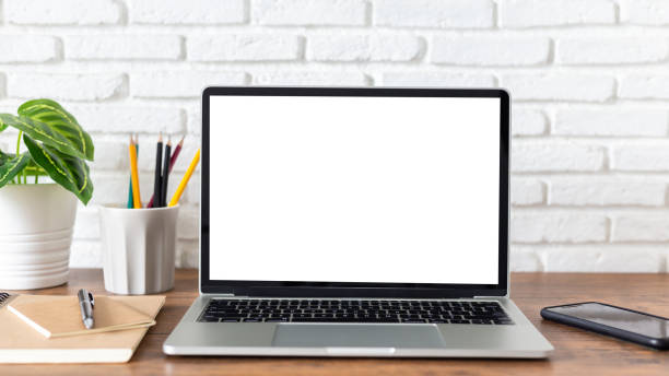 istock laptop computer with blank white screen, with workspace and office supplies on a wooden desk 1248982575