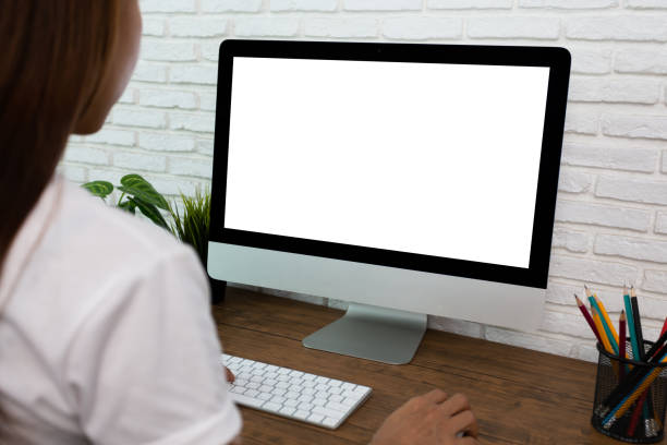 istock woman working empty screen computer on wood desk in home office 1248982576