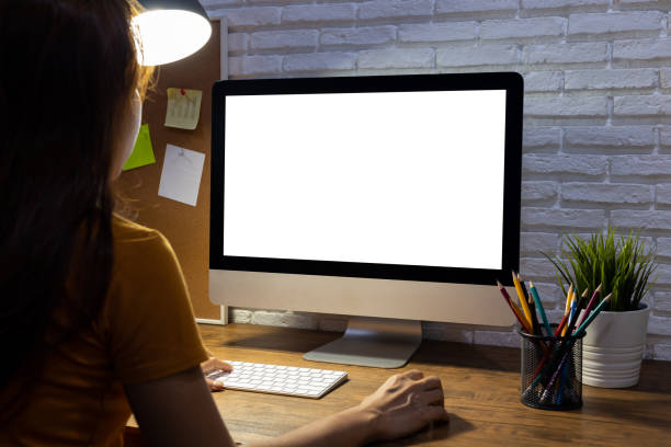 istock woman working empty screen computer mockup on wood desk in office. 1248982642