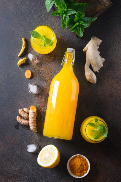istock Jamu Indonesian herbal beverage with natural ingredients turmeric, ginger on brown background. Vertical. View from above. 1248983878