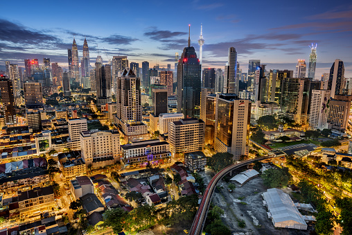 Kuala Lumpur, Malaysia - October 23, 2019: Kuala Lumpur skyline with Petronas Twin Towers and Menara Tower taken from above at sunrise time