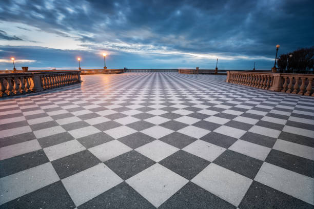 Mascagni terrace at dusk, Livorno, Italy Mascagni terrace with his chessboard pattern floor taken at dusk with a fantastic cloudy sky, Livorno, Italy livorno stock pictures, royalty-free photos & images