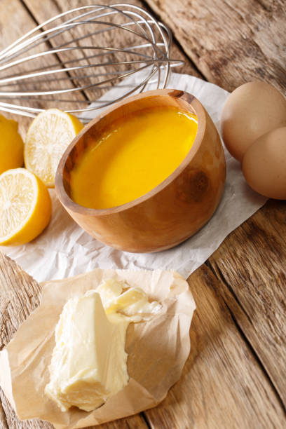istock Freshly prepared hollandaise sauce with ingredients close-up. vertical 1248987796