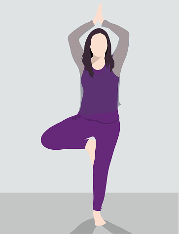 Dark haired women in vrkasana pose yoga pose, wearing a purple solid colour workout outfit