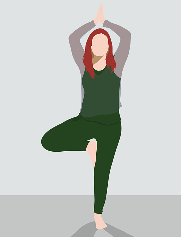 Red haired  women in vrkasana pose yoga pose, wearing a green solid colour workout outfit