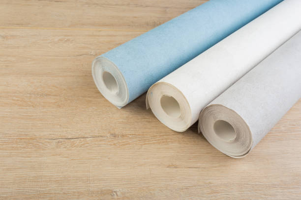 istock several rolls of multi-colored paper wallpaper on a wooden table 1248992228