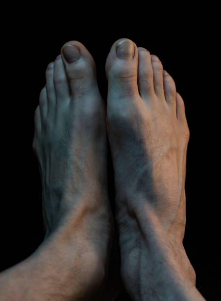 istock Adult feet over a black background 1248992432