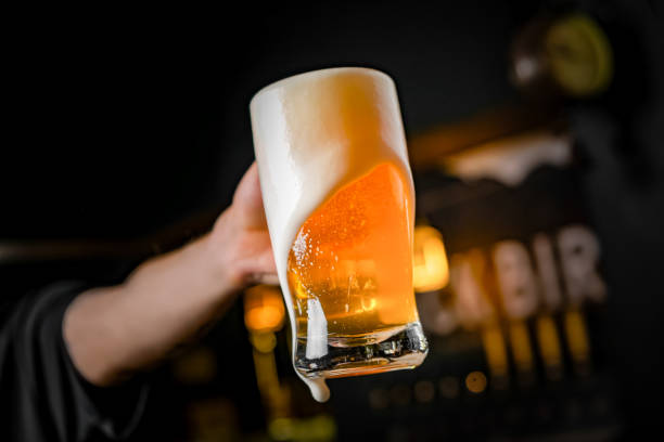 mug full of chopp, with chopp pilsen on a rustic table.