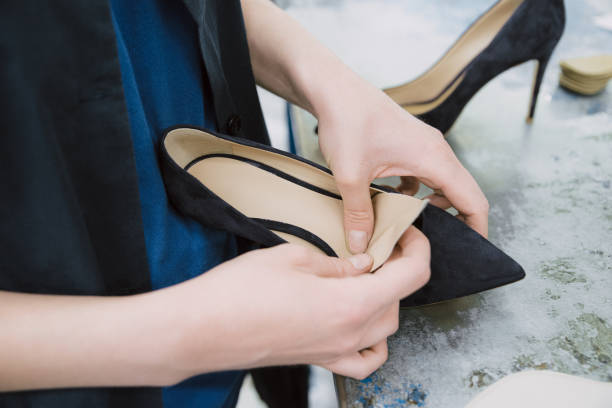 istock Women's hands build heeled shoes 1248993037