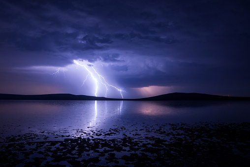 Massive triple lightning over the salt lake with reflection