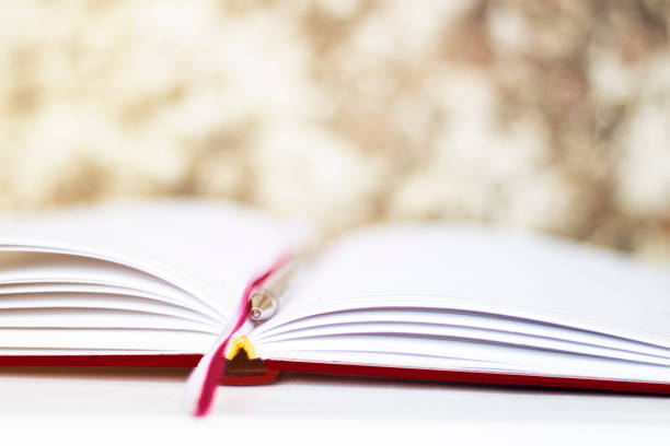 Blank textbook opening with hands. Two hands opening a blank book. Blank template for rotoscoping words inside an open book. Holding a book with two hands, it is opened and then closed.