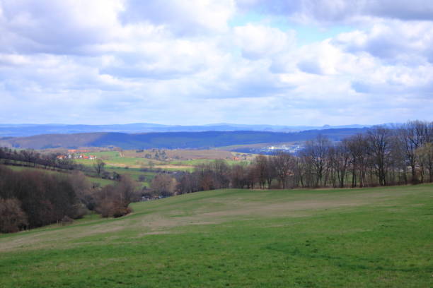 istock sunny idyllic rural landscape with fields and meadows in Germany 1248998854