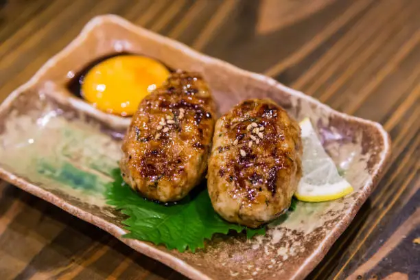 Photo of Traditional Japanese grilled chicken, Yakitori, with marinated egg yolk